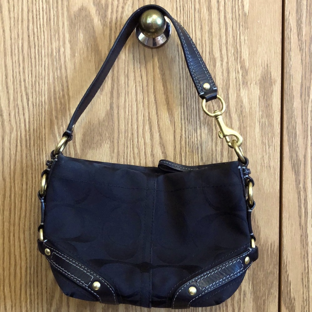 Coach black purse with gold accents.